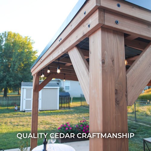 Quality cedar craftsmanship pergola with pendant lights and a table in a backyard