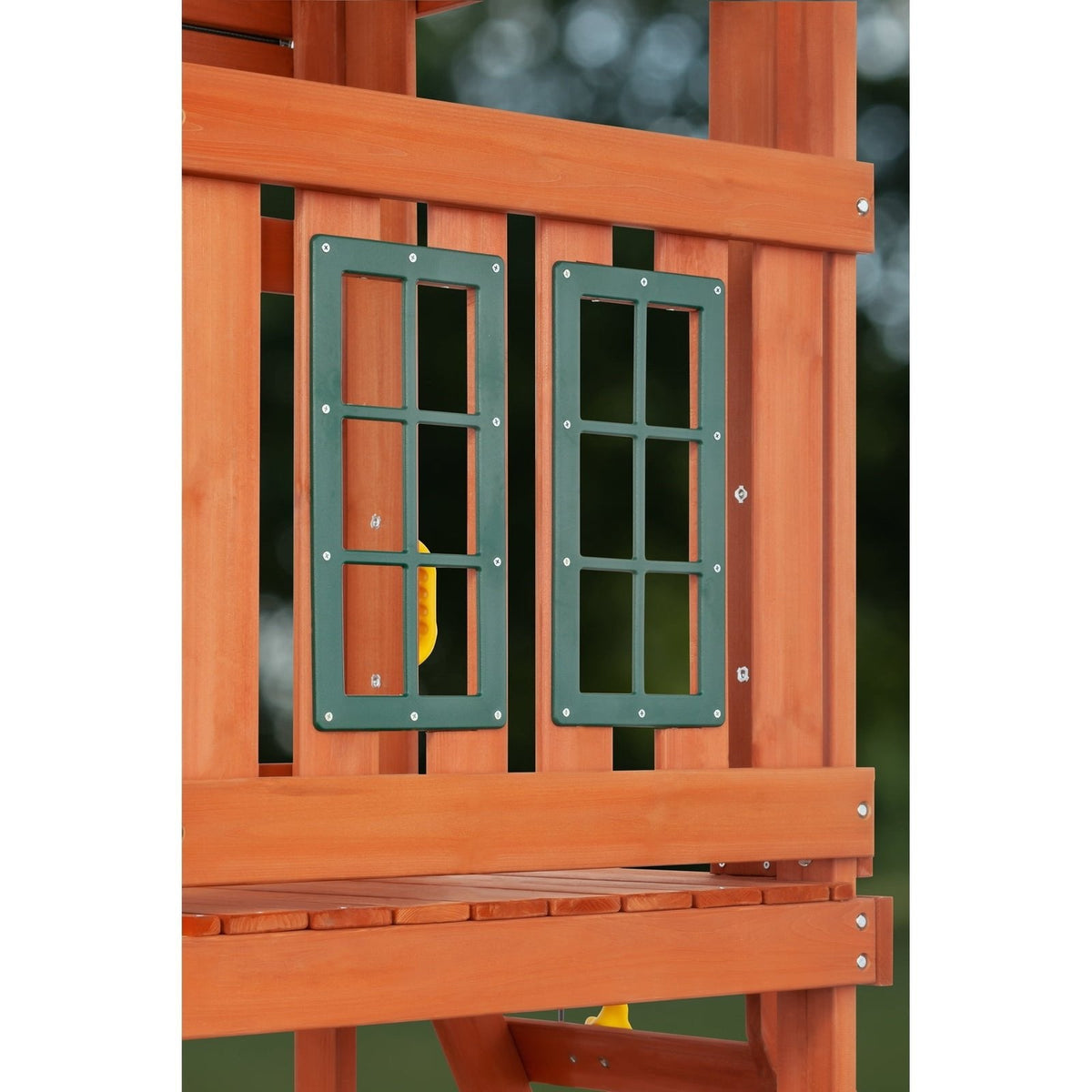 Wooden playset features two green framed windows on a platform with a bench.