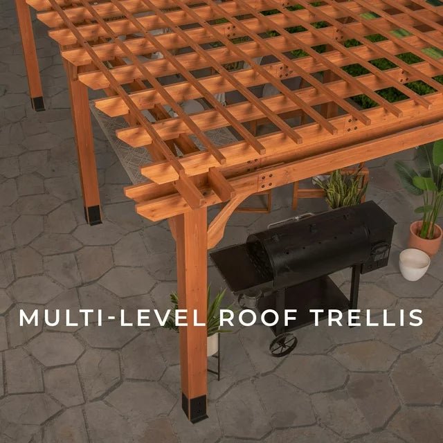 Wooden pergola with a grill and plants on a stone patio.